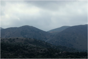 Rogdio peak in the distance with earth excavations seen on the right of it